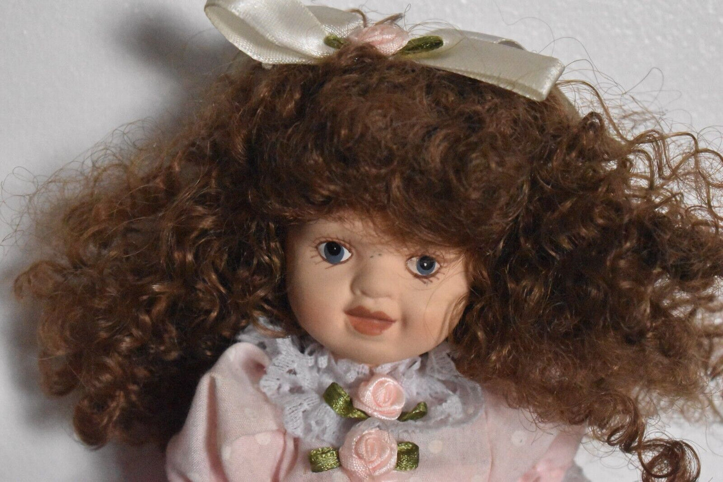 Vintage Bisque Doll Brown Curly Hair, Blue Eyes and Pink Dress