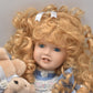 Vintage Porcelain Doll With Teddy Bear Blonde Hair, Blue Eyes and Blue Silk Dres