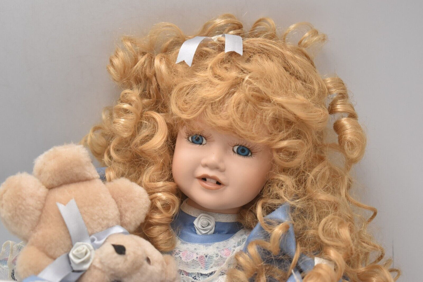 Vintage Porcelain Doll With Teddy Bear Blonde Hair, Blue Eyes and Blue Silk Dres