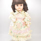 Vintage Porcelain Doll Brown Hair, Brown Eyes and Floral Dress