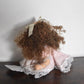 Vintage Bisque Doll Brown Curly Hair, Blue Eyes and Pink Dress