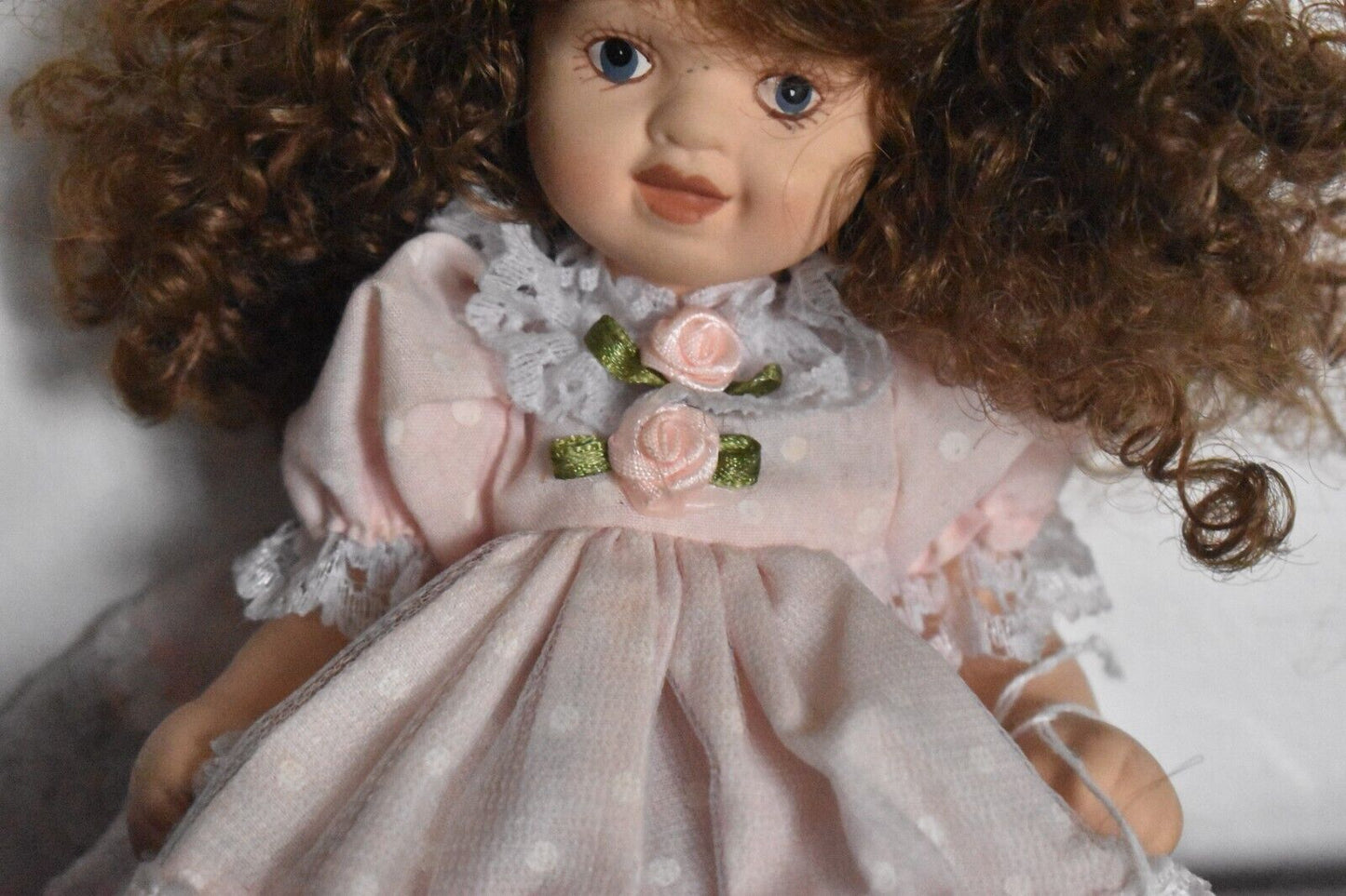 Vintage Bisque Doll Brown Curly Hair, Blue Eyes and Pink Dress