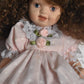 Vintage Bisque Doll Brown Curly Hair, Blue Eyes and Pink Dress