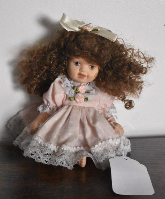 Vintage Bisque Doll Brown Curly Hair, Blue Eyes and Pink Dress