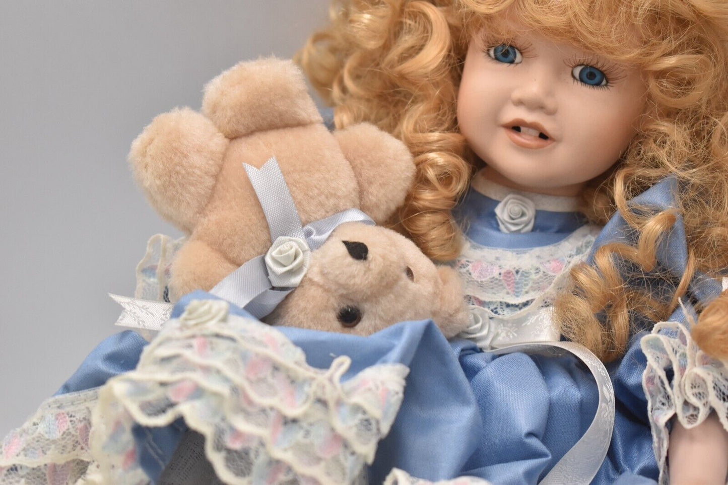 Vintage Porcelain Doll With Teddy Bear Blonde Hair, Blue Eyes and Blue Silk Dres