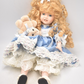 Vintage Porcelain Doll With Teddy Bear Blonde Hair, Blue Eyes and Blue Silk Dres