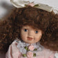 Vintage Bisque Doll Brown Curly Hair, Blue Eyes and Pink Dress