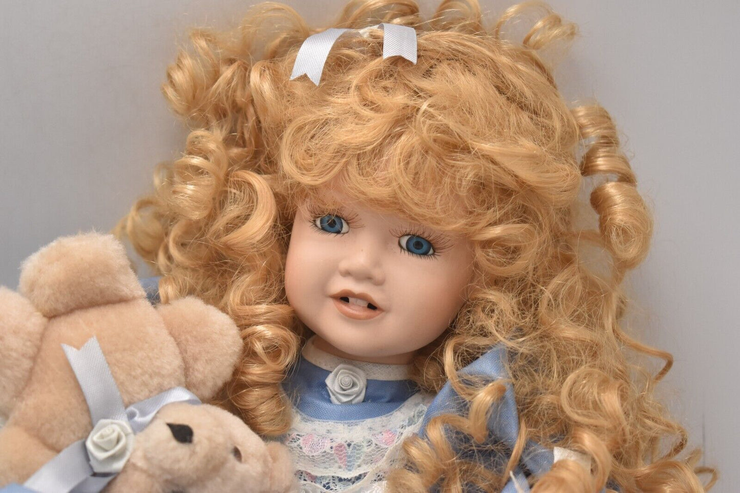 Vintage Porcelain Doll With Teddy Bear Blonde Hair, Blue Eyes and Blue Silk Dres